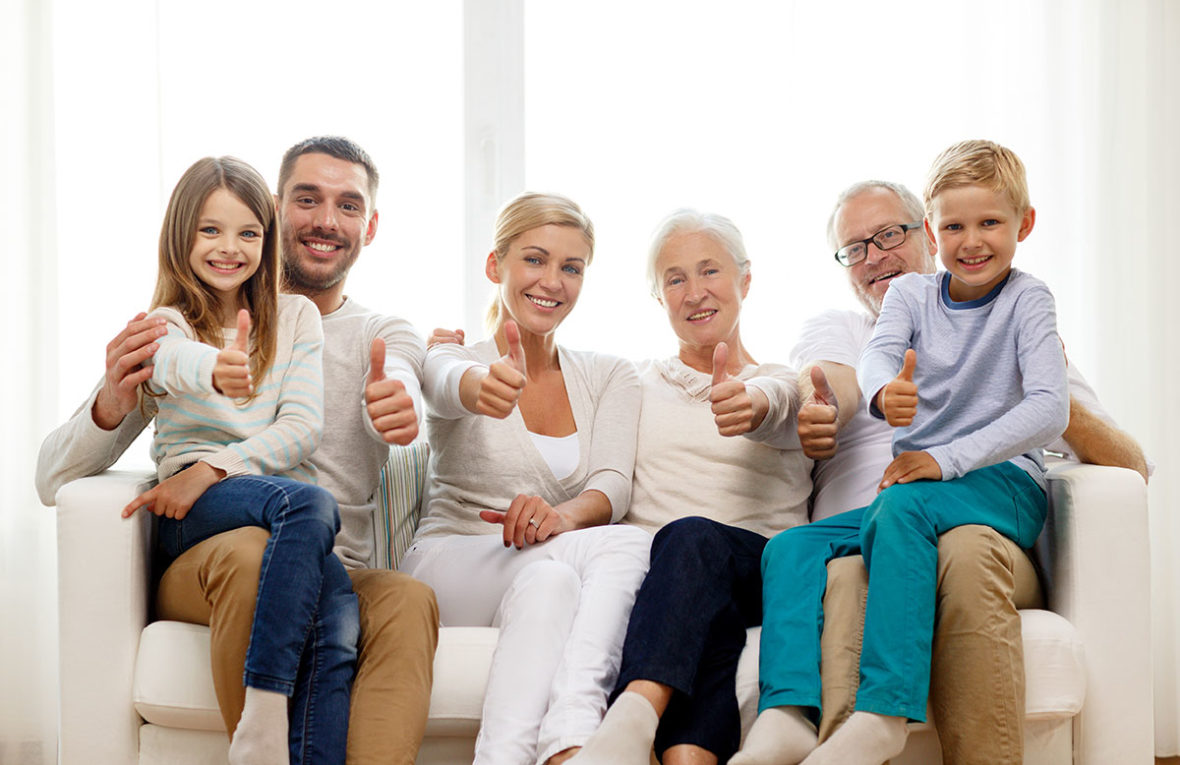 Family on couch giving thumbs up when asked about their homeowners insurance in New York