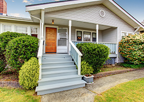 Home with stairs leading to front porch, protected by homeowners insurance in Amityville NY